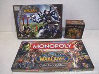 Front view of all three boxed items: Mega Bloks Sea of Anger, Trivial Pursuit, Monopoly Collector's Edition