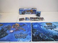 Full lot view showing boxed set, stack of cards, two playmats