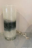 Full view of glass cylinder lamp with cord