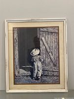 Full frontal view of framed print with boy and barn scene