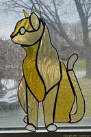 full view of stained glass cat panel against window