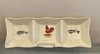 Full front view of ceramic divided tray showing rooster and leaf motifs