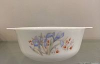 Side view of white casserole showing Blue Iris floral pattern