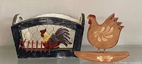 Front view of both wooden rooster basket and hen figurine