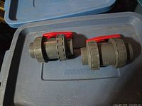 Both PVC ball valves top view showing handles and union ends