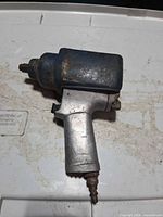 Left side view showing blue cover, aluminum handle, air inlet, overall wear