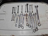 All 18 combination wrenches laid out on lid showing full set and relative sizes