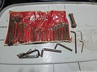 Red vinyl Toolex pouch with hex keys, separate folding set and loose keys