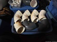 Tray containing four white and two gray 3-in PVC 90° elbows