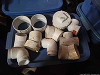 Overview of PVC fittings on blue tote lid