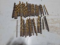 All drill bits laid out showing variety of sizes and TiN coating