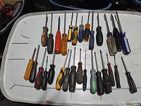 All 29 screwdrivers laid out on white lid