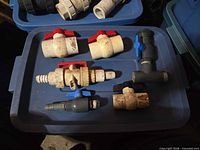 Overview of six PVC valves and fitting on bin lid