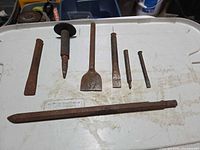 All seven chisel and demolition bits laid out to show type and size