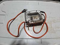 Full view of jigsaw with cord and attached rusty blade