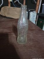Full view of Coca-Cola contour bottle standing upright