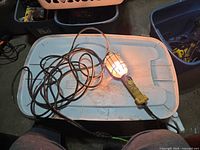 Light illuminated, showing operation, cord coiled