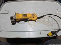 Full view of DeWalt angle grinder with damaged cord and missing guard/handle