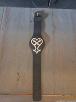 Front view of black Disney Accutime watch showing emblem and strap