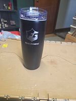 Front view of black First General stainless steel tumbler showing logo