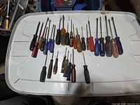 All screwdrivers spread out on lid for quantity and variety view
