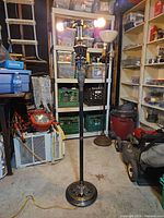 Full view of brass and marble floor lamp in storage area