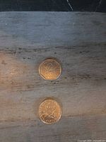 Obverse and reverse of both 1 franc coins