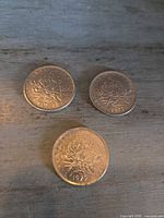 Obverse of three French 5 Francs coins, dates visible 1971 (2) and 1972 (1)
