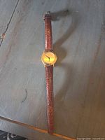 Full view of Gucci watch laid flat showing entire strap and case