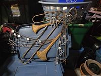 Full view of metal musical wall hanging resting on storage bin