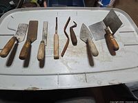 All seven hand tools laid out on lid