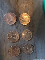 Six Kennedy half dollars arranged in two columns