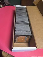 Long white storage box filled with stacked Magic cards