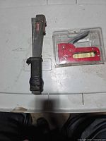 Both staple guns side by side on surface