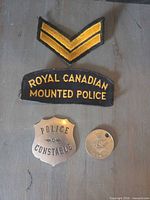 Group view showing RCMP patch, chevron patch, constable badge, and Jubilee medallion