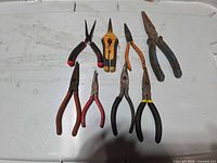 All eight tools laid out on white surface