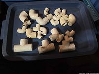 Tray containing multiple white PVC elbow and tee fittings