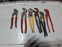 All seven pliers laid out showing handles and jaws