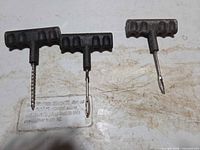 All three T-handle tools side by side on work surface