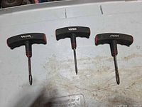 Front view of three Victor T-handle tools laid out side by side