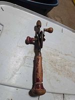 Full view of the hand drill showing handle and frame