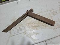 Sliding bevel gauge opened on plastic surface