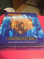 Lid showing Magic: The Gathering Return to Ravnica Holiday Gift Box text and artwork