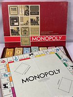 Open box showing board, banker tray with money and cards