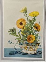 Close-up of floral print showing yellow and orange blossoms in decorative bowl, artist signature visible