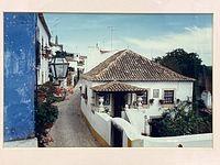 Full view of photograph showing street scene and mat