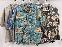 Five of the six shirts on hangers showing variety of prints