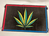 Full view of poster under normal light showing leaf graphic, borders, and flocked surface