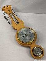 Full view of wood banjo weather station showing barometer, thermometer, hygrometer