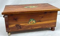 Front and side view of cedar chest showing size, feet, front rabbit decal